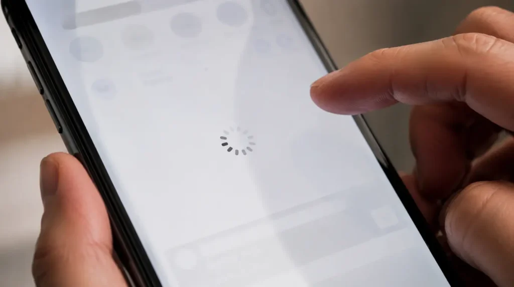 Close-up of a smartphone screen frozen on a blank loading state during checkout